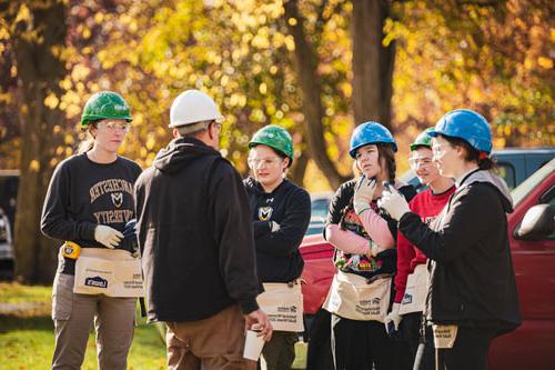 A group of honors students doing volunteer work for habitat for humanity